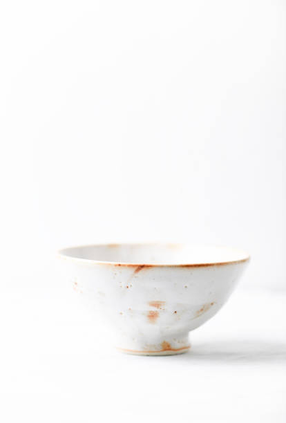istock Traditional ceramic bowl on bright wooden background. Copy space. 1479463954