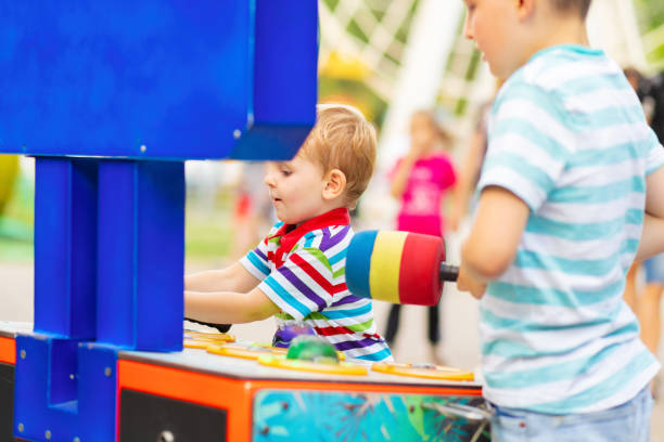 istock Children playing whack a mole arcade game at an amusement park 1479465172