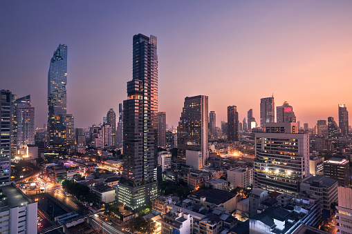 Night view of urban skyline at dusk. Downtown with skyscrapers and modern architecture. Bangkok, Thailand.