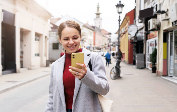 istock Woman traveling around town using digital map mobile app navigation on her smartphone. 1479466504