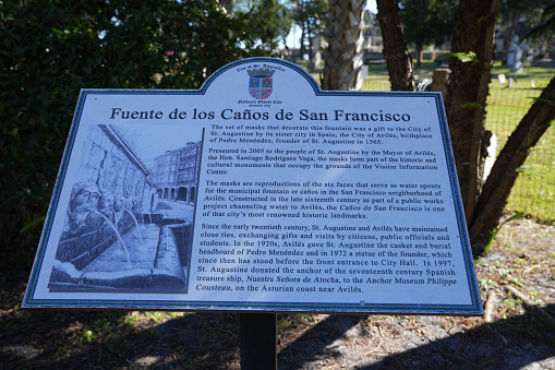 St. Augustine, Florida - December 28, 2022: Historical marker and placard for the Fuente de los Canos de San Francisco mask fountain