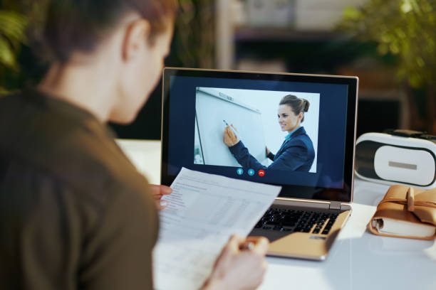 istock Seen from behind modern business woman using video chat 1479467730