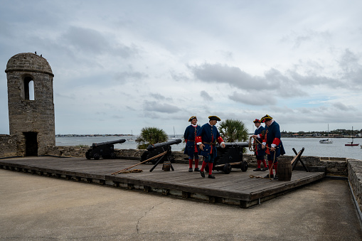St. Augustine, Florida - December 31, 2022: Reenactors prepare for a cannon firing demonstration at Castillo de San Marcos National Monument fort