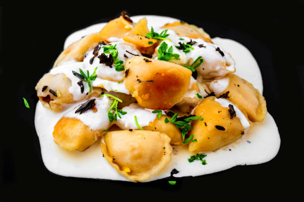 istock Roasted stuffed dumpling with creamy sauce on black. 1479468796