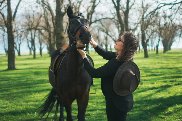 istock Cheerful woman with her horse 1479470608