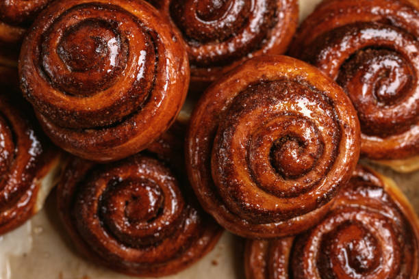 istock Freshly baked homemade Cinnamon rolls or Cinnamon buns on baking paper 1479473888