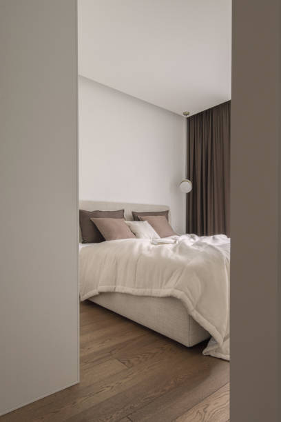 istock Modern minimalistic bedroom interior design in brown and white shades 1479474036