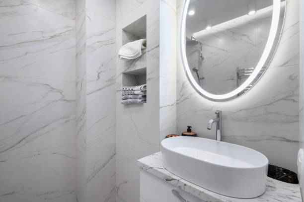 istock White bathroom interior with marble tiles on the walls 1479474771