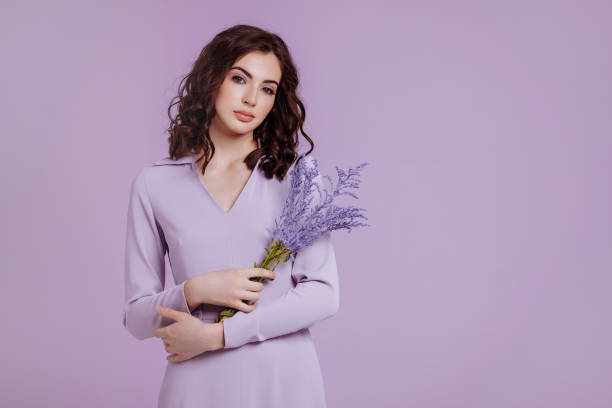 istock Attractive woman with bouquet on lilac background 1479478666