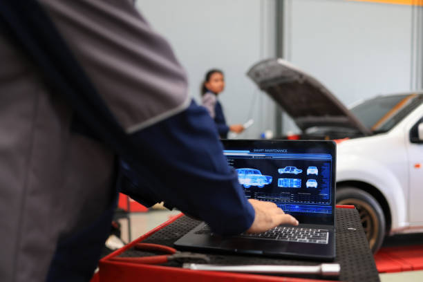istock Mechanical engineer check and maintenance, smart maintenance system in modern car garage. Auto mechanic work with smart software maintenance vehicle 1479481750