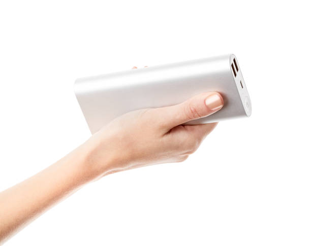 istock Silver power bank on hand isolate. Power bank for charging mobile devices. Smart phone charger with power bank. battery bank. External battery for mobile devices. 1479481916
