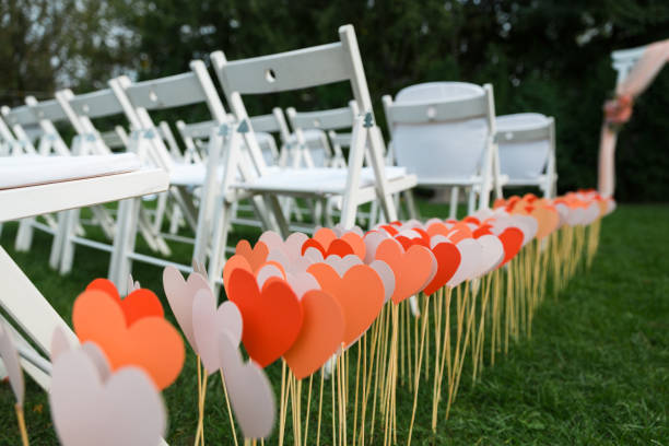 Wedding chairs set up before the ceremony. Rows of white empty chairs on a lawn before a wedding or ceremony.