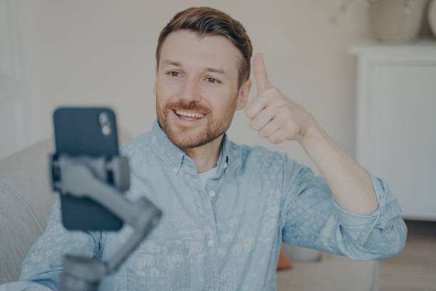 istock Young man showing thumbs up gesture while video chatting on phone 1479485219