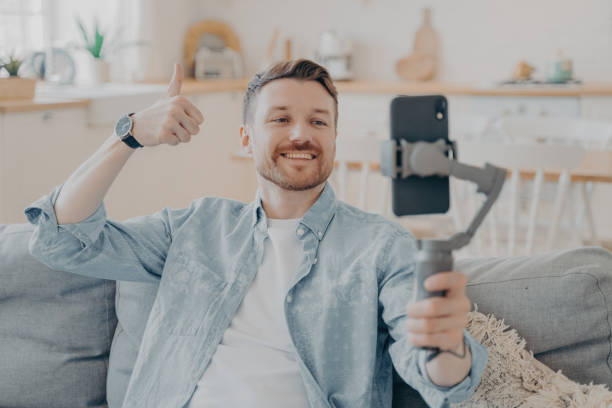 istock Young man in video call expressing his satisfaction by showing thumbs up 1479485285