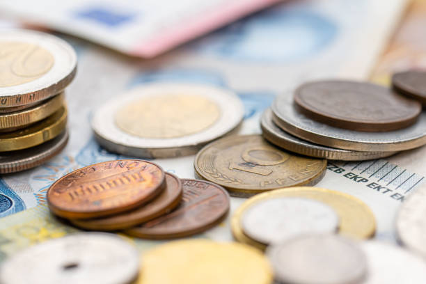 istock Assortment of coins on bank notes from different countries.. 1479485324