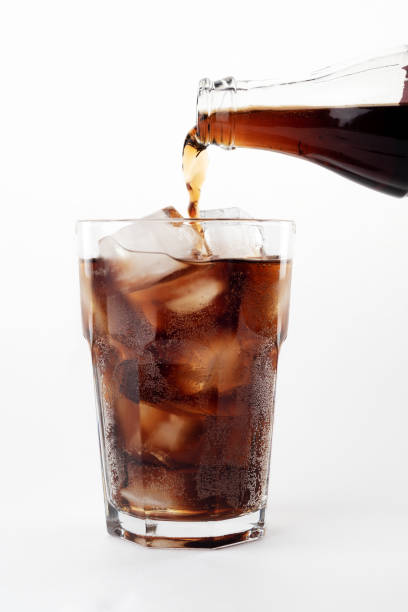 istock Pour cold soda from a glass bottle into a glass with ice. 1479491743