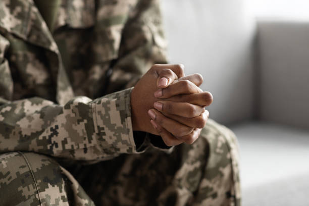 istock Unrecognizable Black Female Soldier Sitting On Couch With Clasped Hands 1479493327