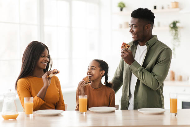 istock African American Family Eating Pie Having Lunch In Kitchen 1479493381