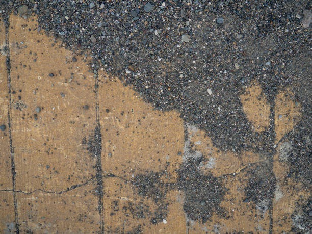 istock Background of brown tiles and small pebbles. Solid material pattern. Pebbles on tiles. Sidewalk surface in the park. Cracks. 1479494529