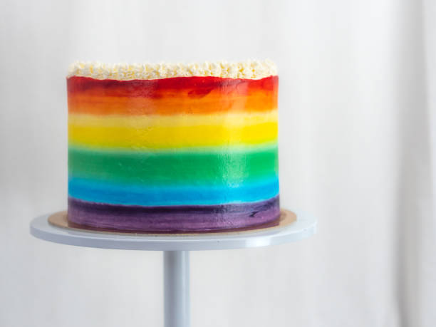 istock chef pastry baker making a frosted cup cake with rainbow colors - lgbt pride celebration anniversary 1479495419