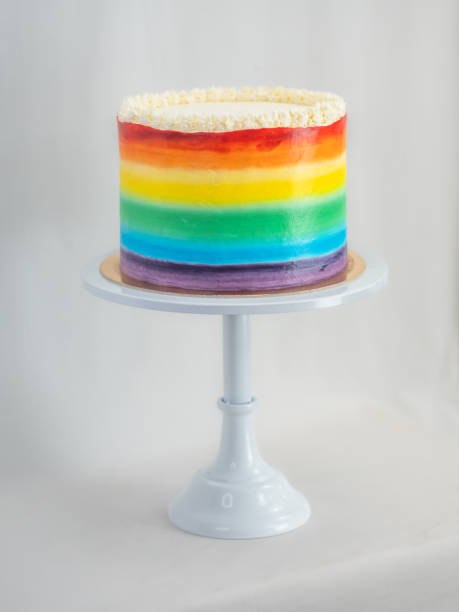 istock chef pastry baker making a frosted cup cake with rainbow colors - lgbt pride celebration anniversary 1479495421