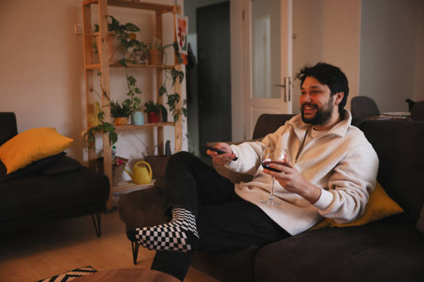 istock Cheerful male person watching TV 1479495445
