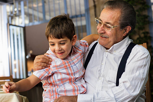 Proud Italian Grandfather plays with his grandson stock photo