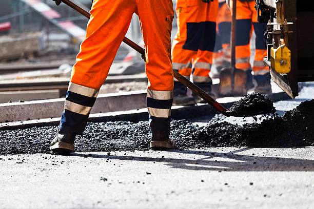 Road construction, worker with shovel Workers on a road construction, industry and teamwork road construction photos stock pictures, royalty-free photos & images