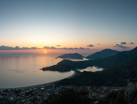 Beautiful sunset at sea with cascading islands silhouettes. Oludeniz Beach from above. Turkey