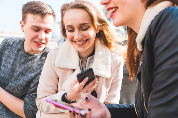 istock Happy group of friends using smartphone and laughing 1479497699