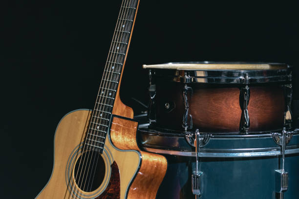 istock Acoustic guitar and snare drum on a black background isolated. 1479499074