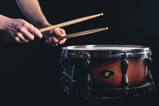 istock A man plays the snare drum against a dark background. 1479500913