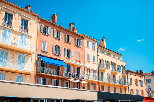 Colorful facades in San Trope, France. Copy space on blue sky