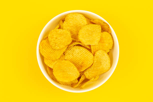 istock Close-up, a plate with potato chips on a yellow background, top view. 1479503382