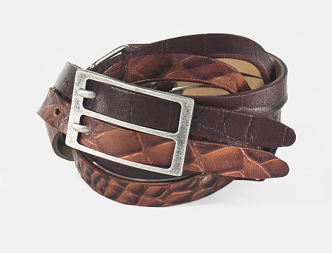 Brown leather belt fastened with buckle, isolated on white, clipping path included