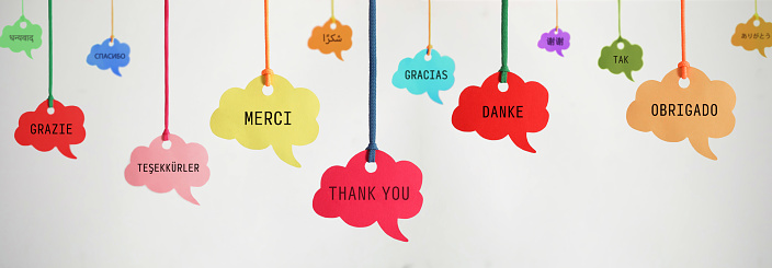 Thank you in different languages ​​on hanging speech bubbles.