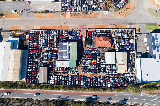 Aerial view Car Wrecker - hundreds of accident cars and used cars as spare parts dispensers. Perth, Western Australia