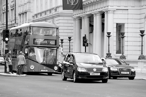 City of Westminster, London, England. 20 August 2021: Eco friendly transport for commuting workers and sightseeing tourists, the red, double decker London buses are a familiar sight in central London