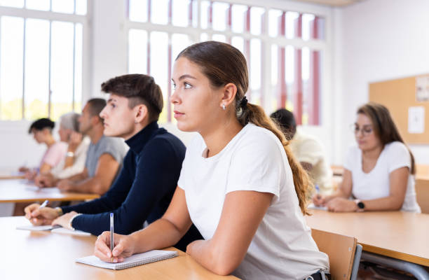 istock Young girl listening to lecture and taking notes in classroom 1479511155