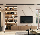 Modern marble TV wall with bookshelf. Home interior design.