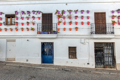 Beautiful facade decorated with pots in Vejer de la Frontera, Spain