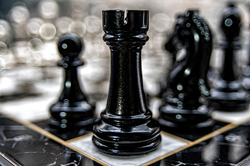 Close up view of chess pieces on a game board.
