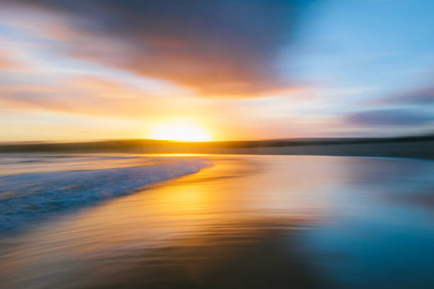 istock Long exposure pan of beach with dramatic golden sunset 1479516735