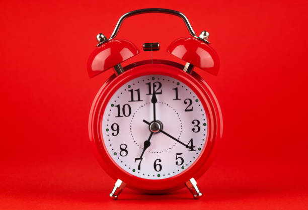 istock Red alarm clock on a red background. 1479518378