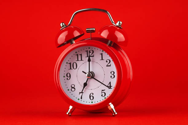 istock Red alarm clock on a red background. 1479518386