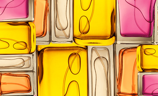 Top view, flat lay of a set of perfume bottles on a on a colorful background