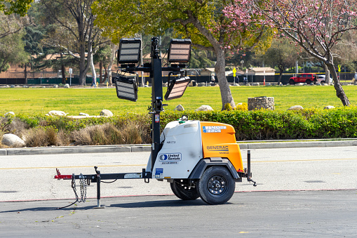 Pasadena, CA, USA – March 8, 2023: A United Rental towable LED light tower by Generac Mobile placed in a parking lot in Pasadena, California.
