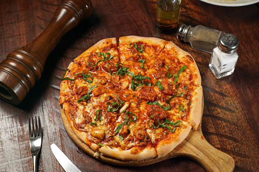 Seafood Marinara Pizza isolated on cutting board top view on table italian fastfood