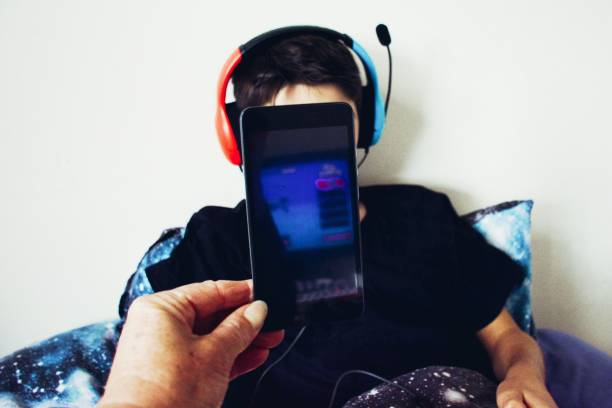 istock Child with Mobile Phone in Front of Face - Child Tech Head Concept 1479525699