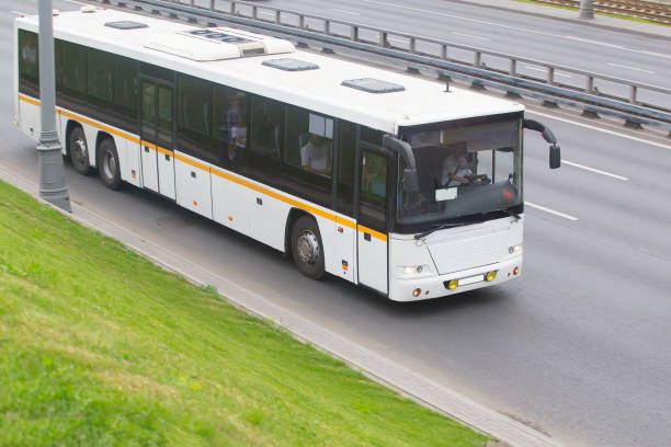 istock City shuttle bus carries passengers down the street 1479534459
